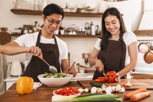 Image,Of,Young,Multicultural,Couple,In,Aprons,Laughing,And,Making